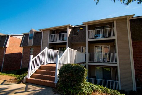 an apartment building with stairs and balconies