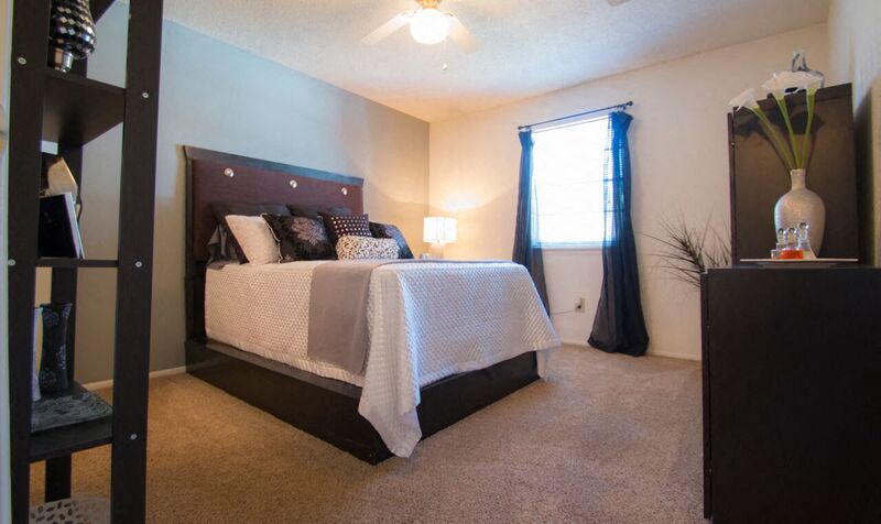 a bedroom with a large bed and a window