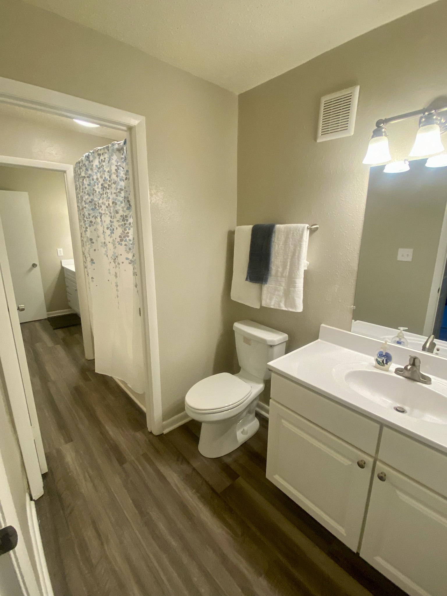 a bathroom with a toilet and a sink and a shower