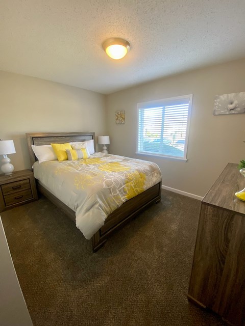 a bedroom with a bed and a window