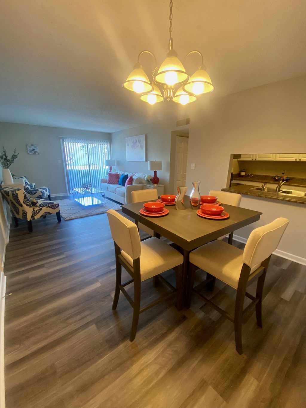 a dining room and living room with a table and chairs