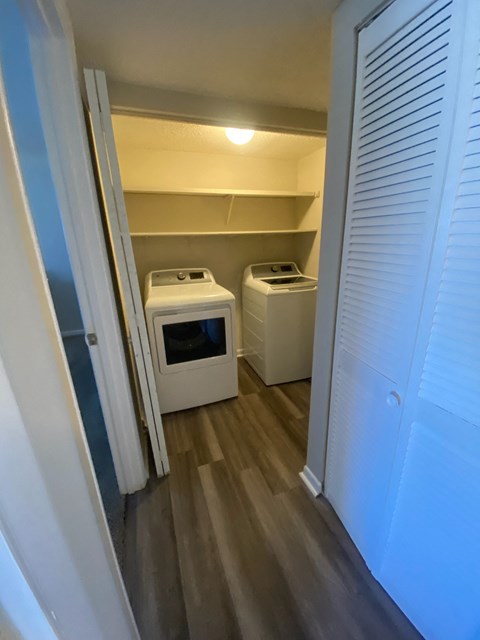 a small laundry room with two washes and a dryer