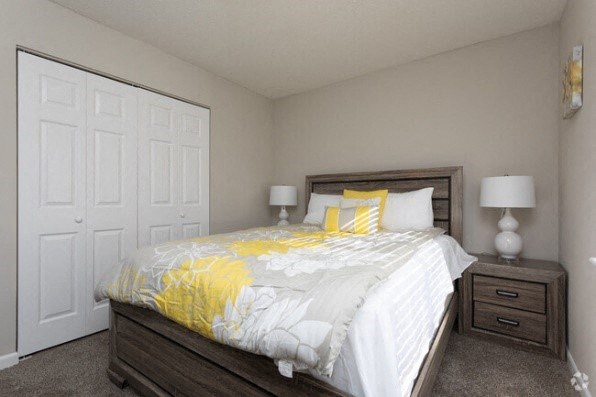 a bedroom with a bed and two lamps