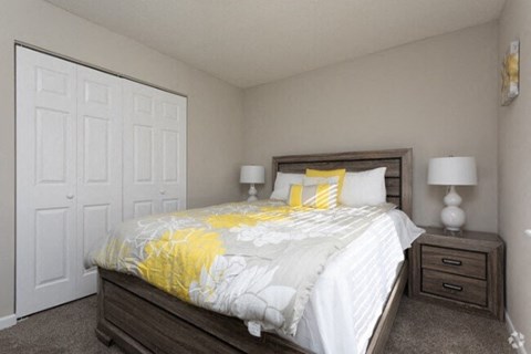 a bedroom with a bed and two lamps