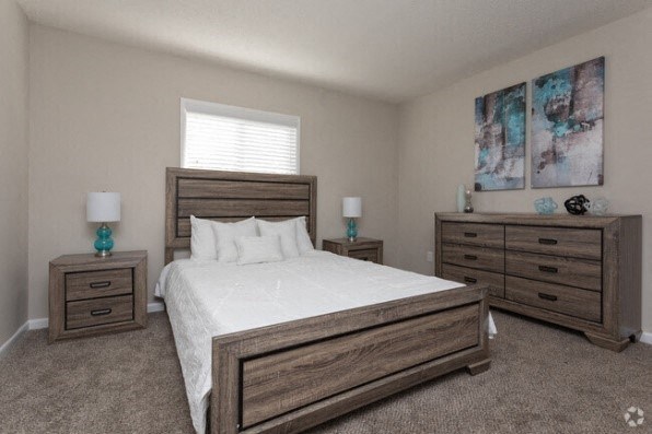 a bedroom with a bed and three dressers