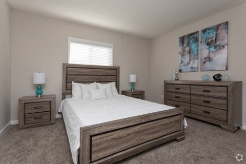 a bedroom with a bed and three dressers