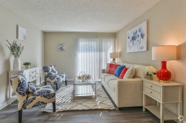 a living room with a couch and two chairs