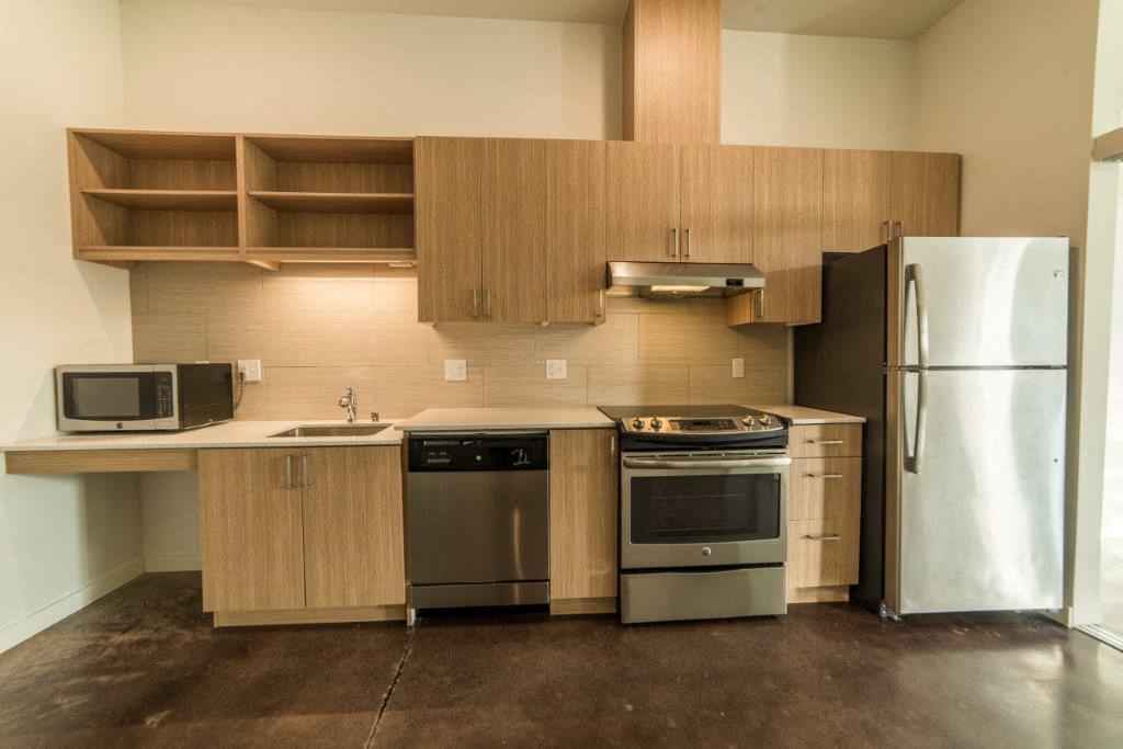 a kitchen with stainless steel appliances and wooden cabinets