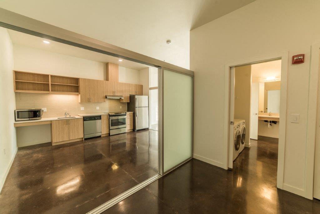 an empty kitchen with a sliding glass door