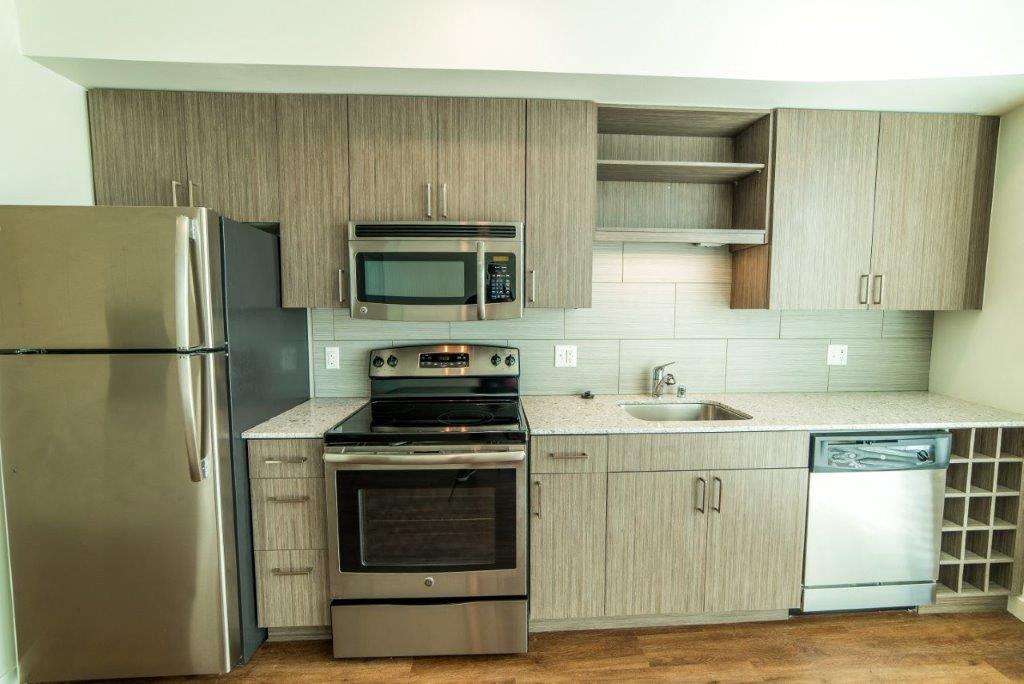 a kitchen with stainless steel appliances and wooden cabinets