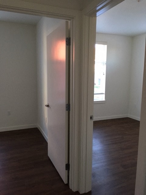 an empty room with a white door and a window