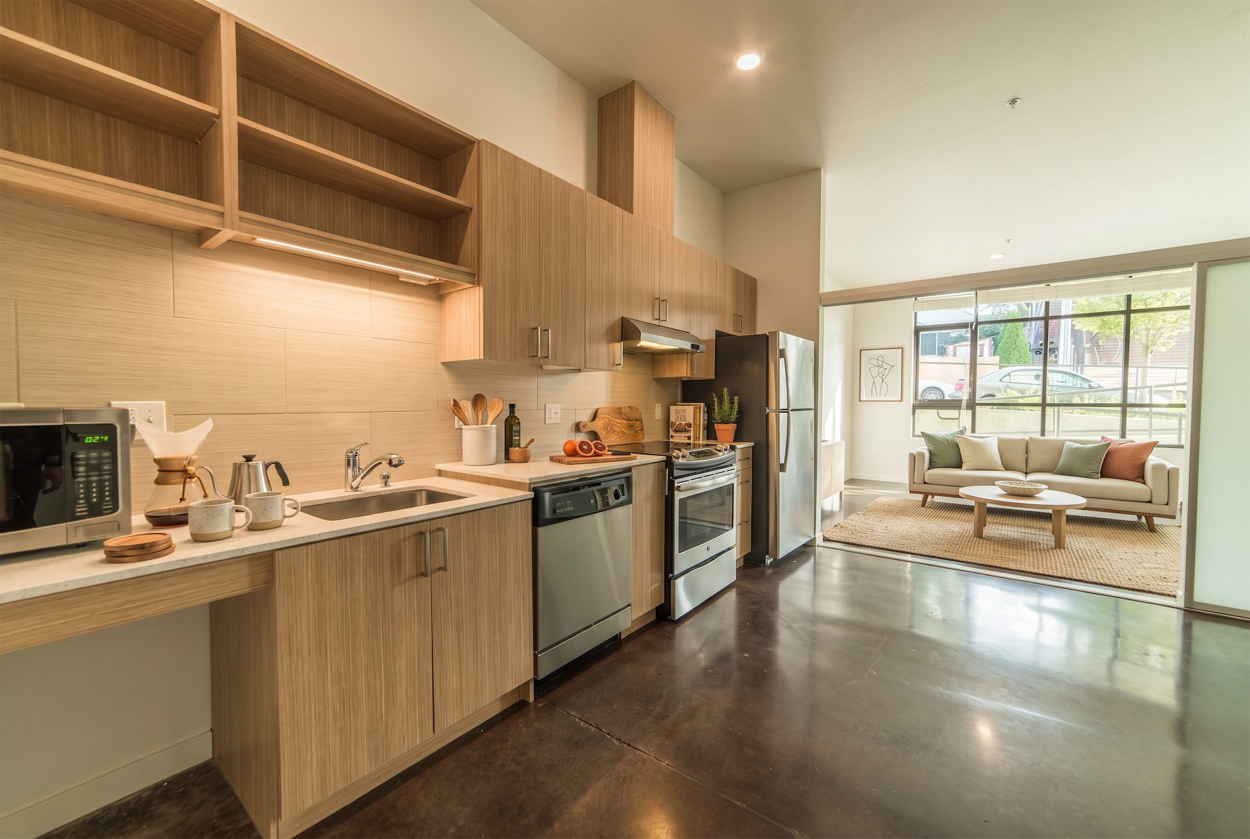 A modern kitchen with wooden cabinets and stainless steel appliances.