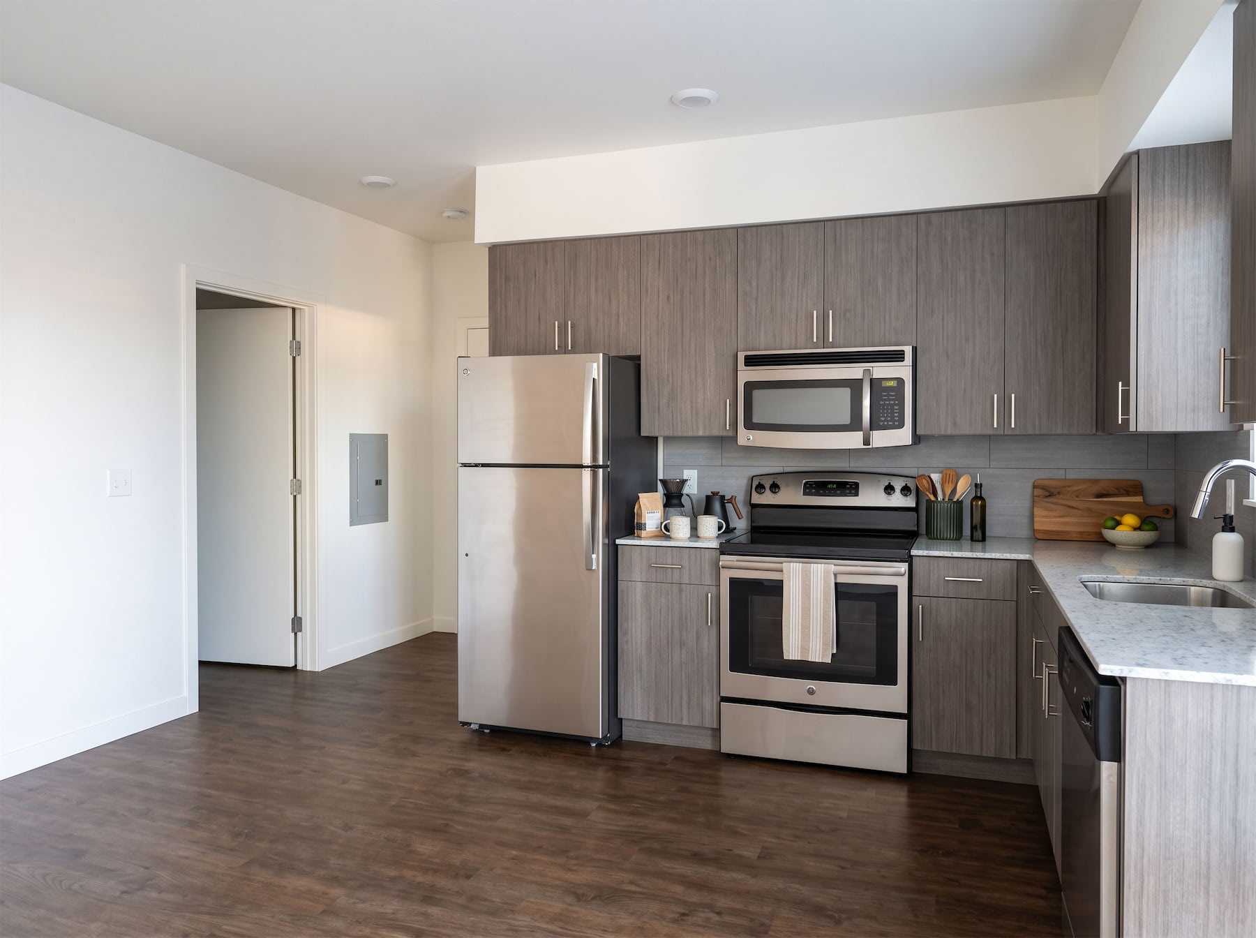 A modern kitchen with stainless steel appliances and wooden cabinets.