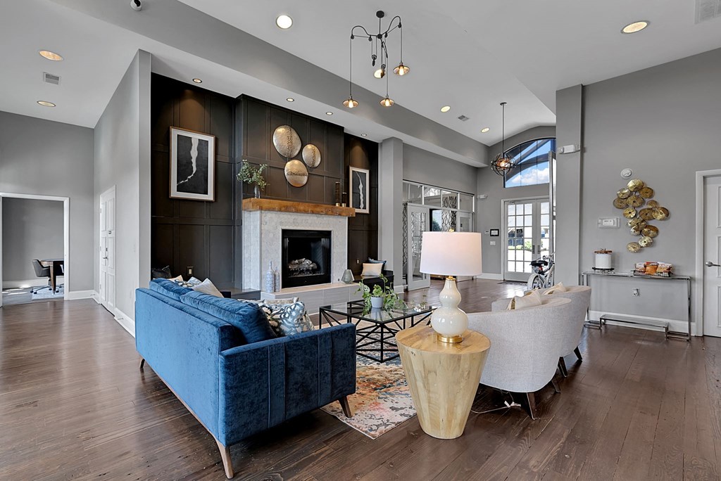 a living room with a blue couch and a fireplace