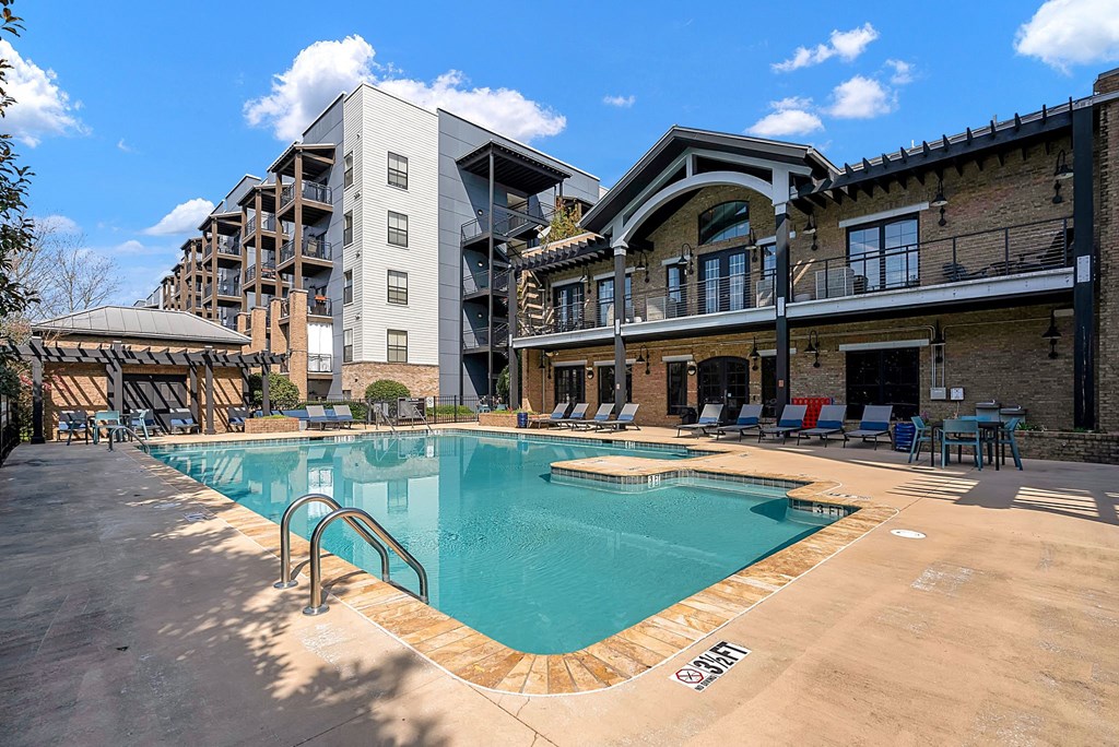 a swimming pool with a building in the background