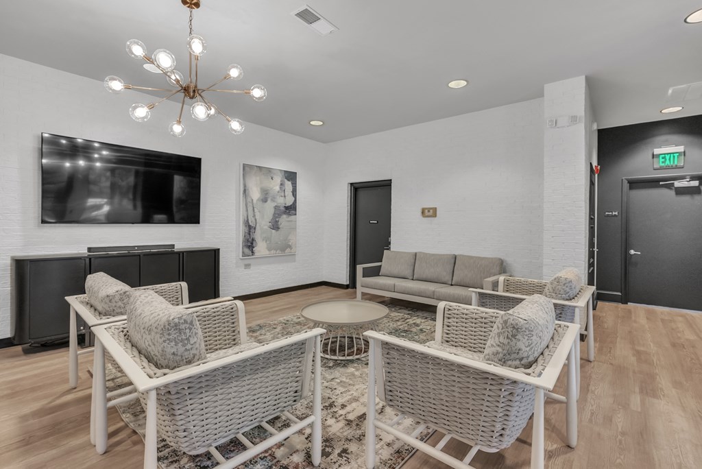 a living room with a couch and chairs and a television