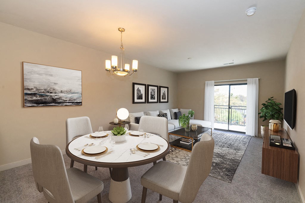 a dining room and living room with a table and chairs