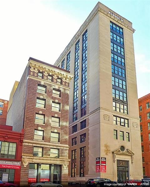 two tall buildings are next to each other on a city street
