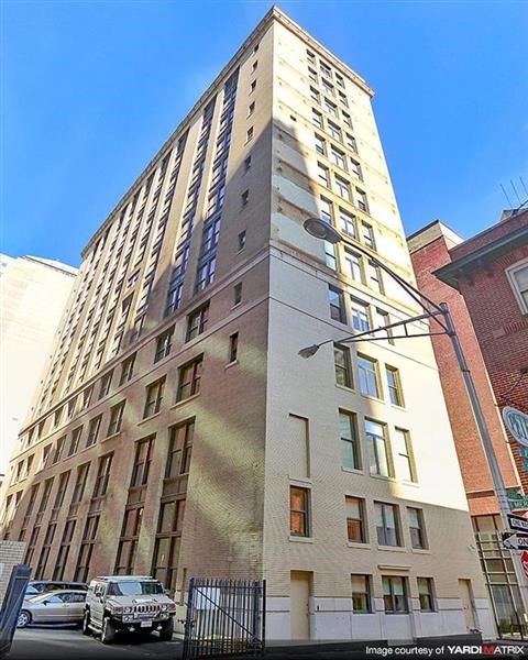 a tall building with a car parked in front of it