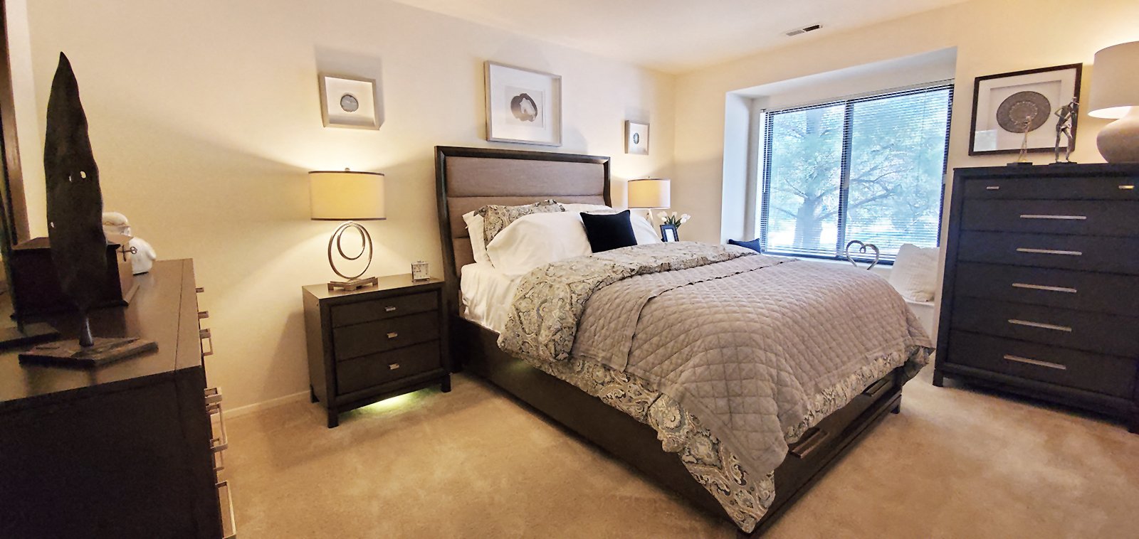 A bedroom with a large bed and a window.