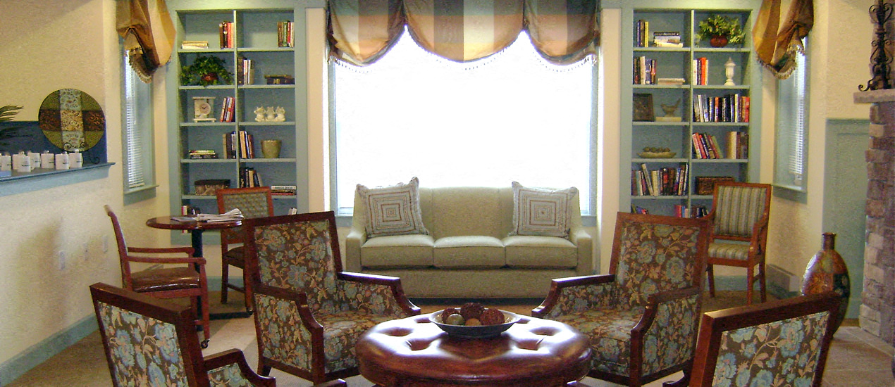 A living room with a couch, chairs, and a coffee table.