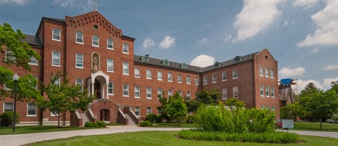 a large brick building with a sidewalk in front of it