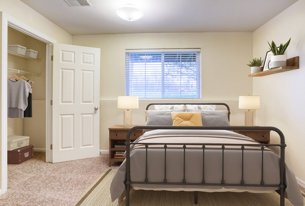 a bedroom with a bed and a closet and a window