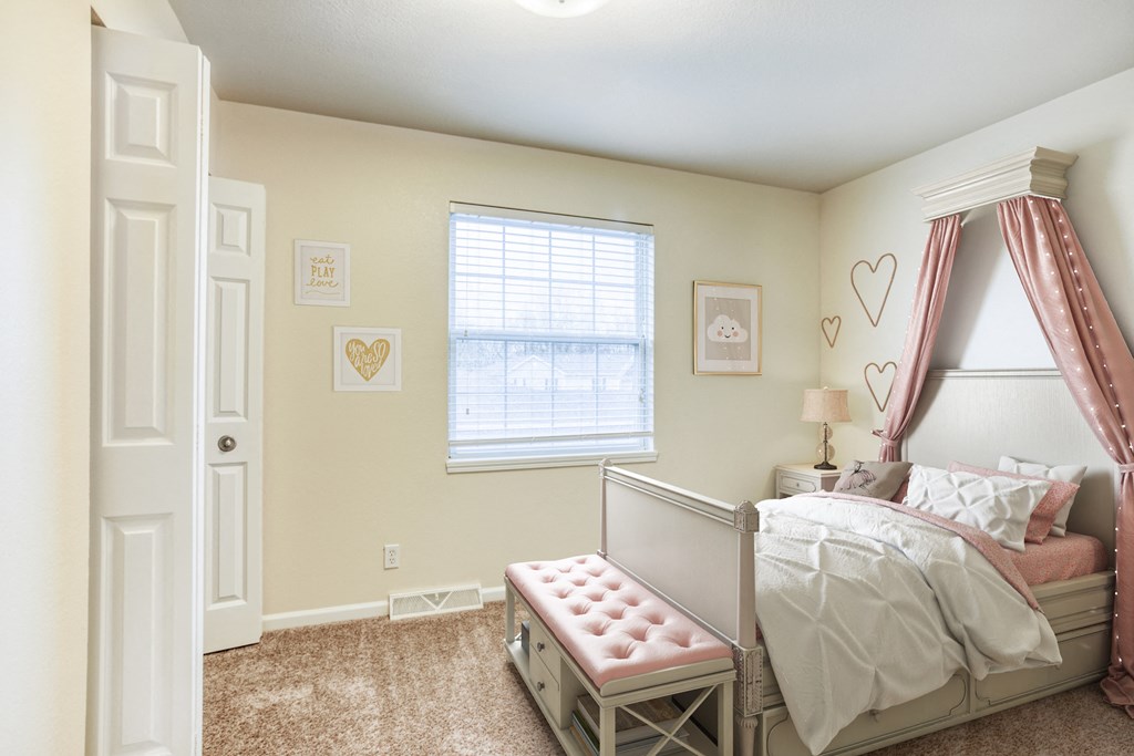 a bedroom with a bed and a dresser and a window