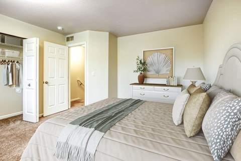 a bedroom with a large bed and a closet