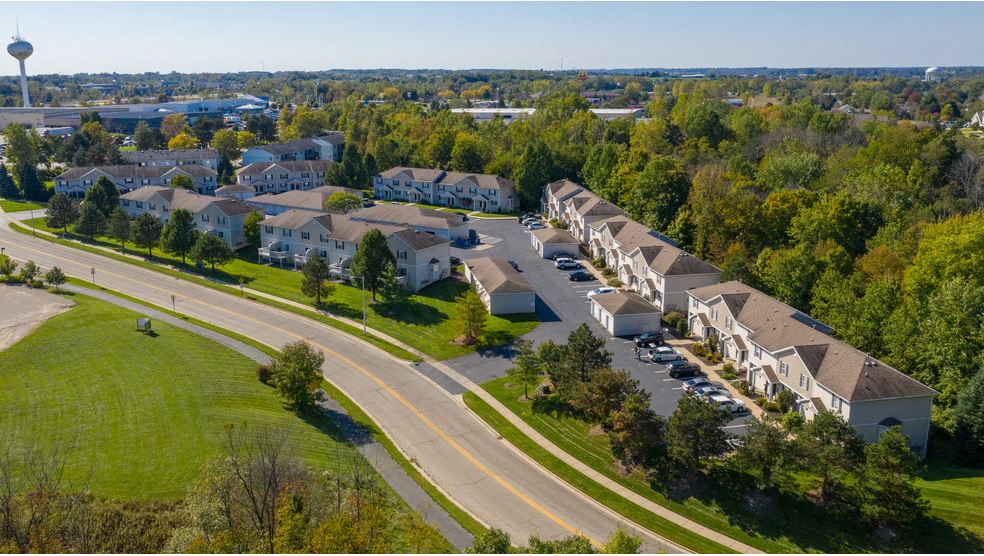 an aerial view of a group of houses on a street