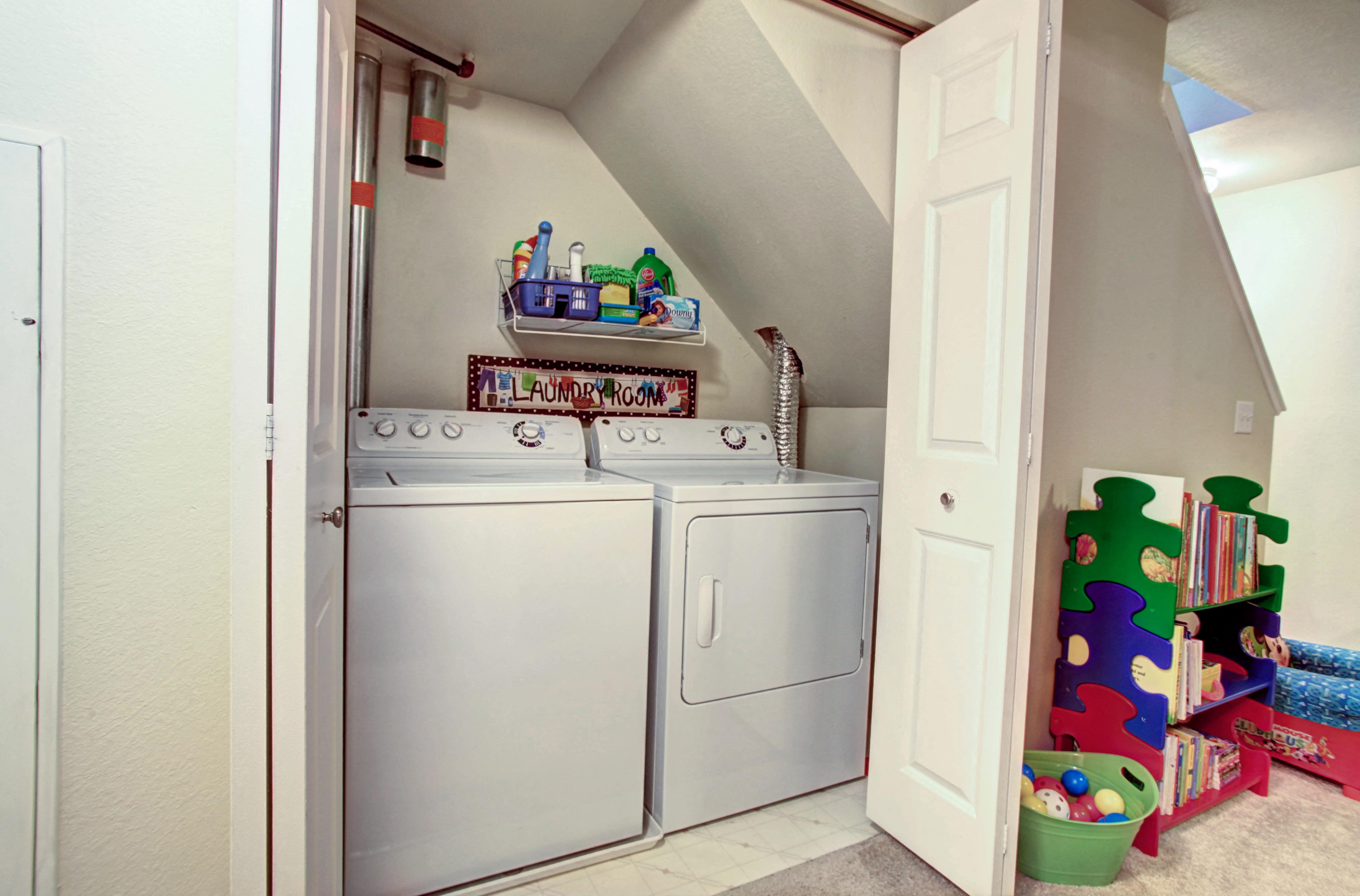 the laundry room has a washer and dryer and a door to the bathroom