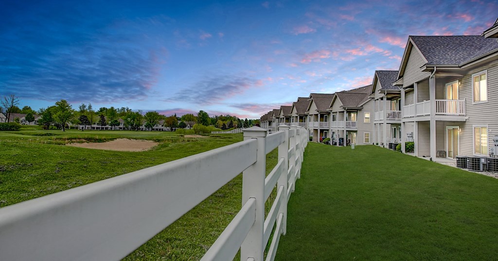 a row of houses with a white fence