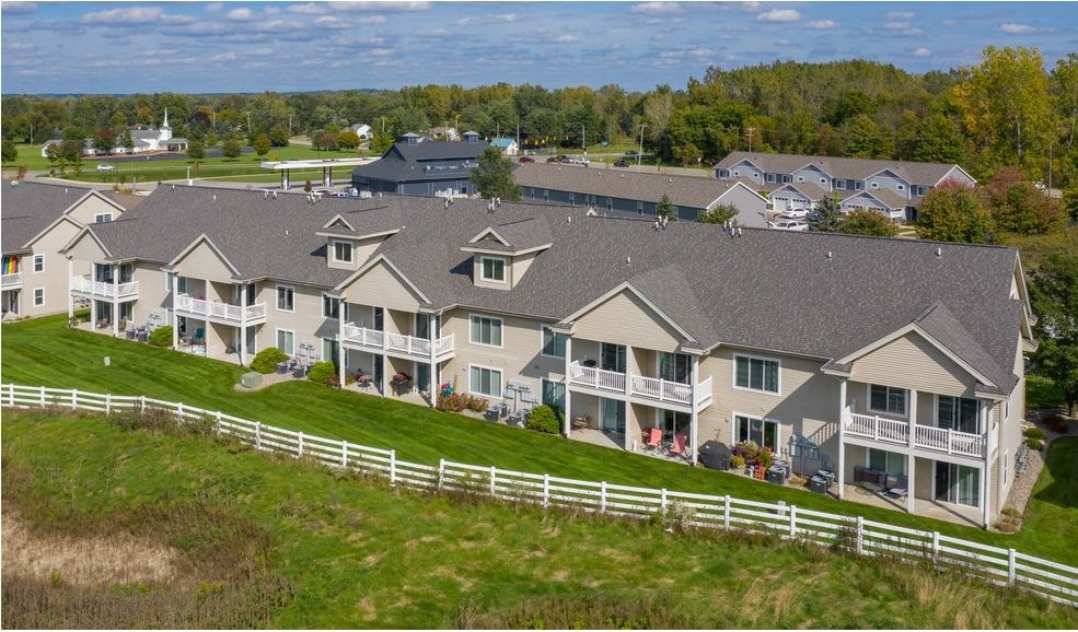 an aerial view of a large estate with a white fence
