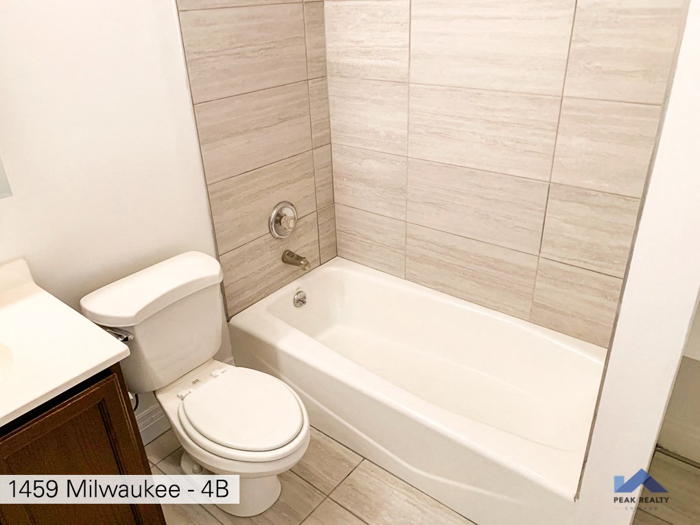 an image of a bathroom with a tub and a toilet