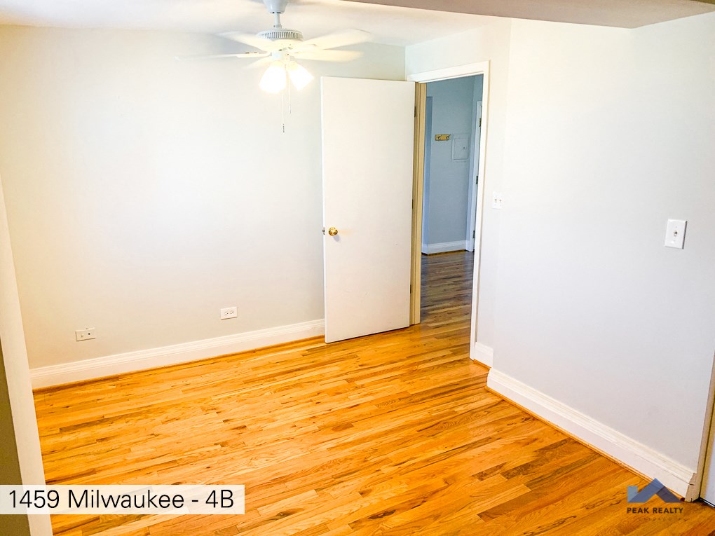 a room with wood flooring and a closet and a ceiling fan