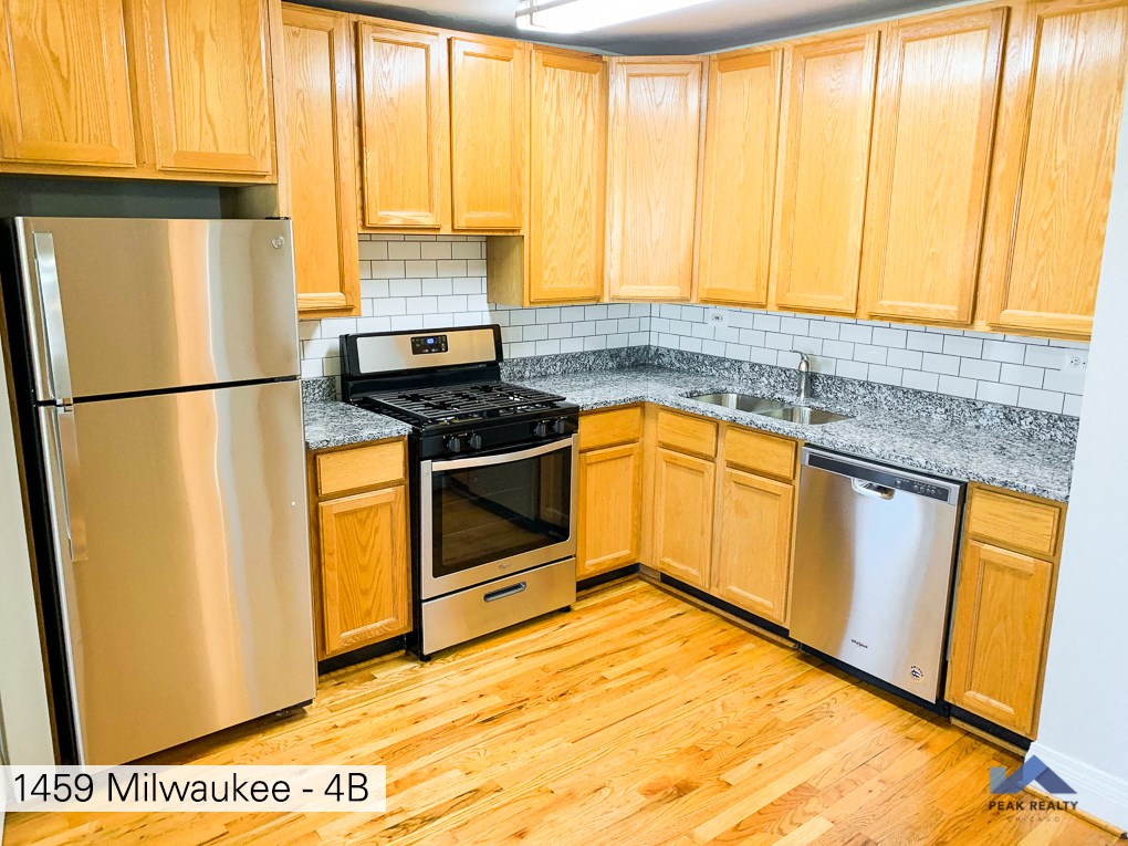 a kitchen with wooden cabinets and stainless steel appliances