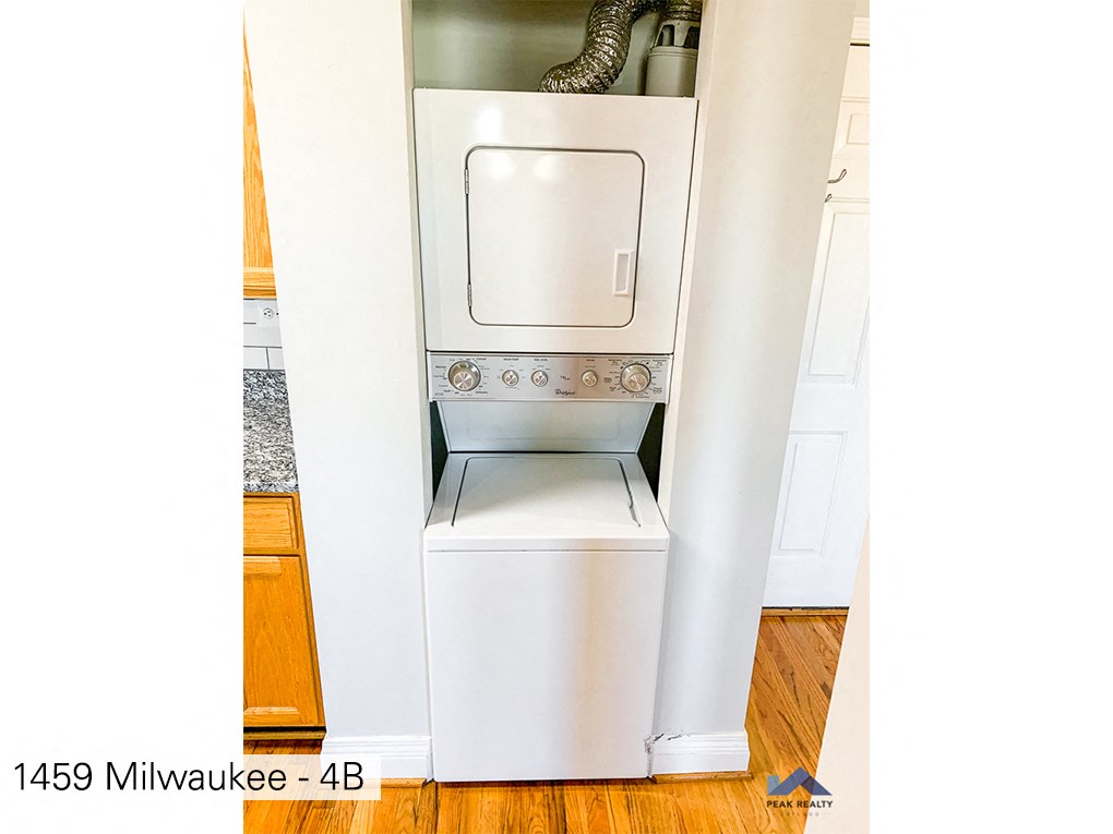 a kitchen with a stove and a washer and dryer