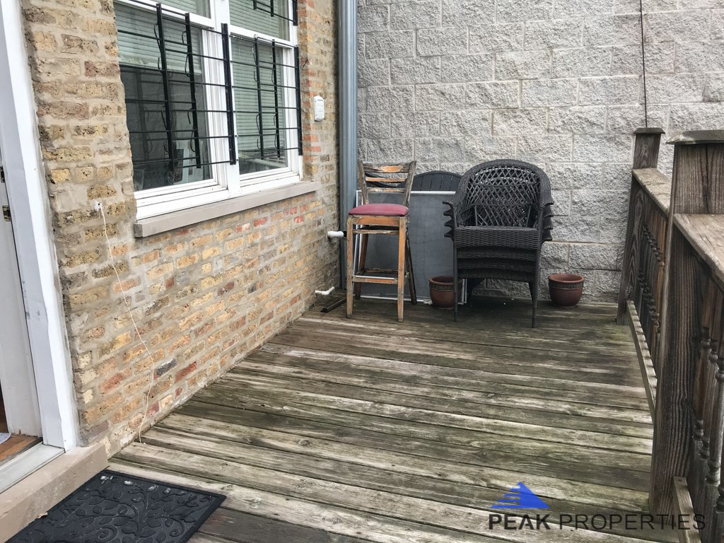 a porch with a chair and a table on it