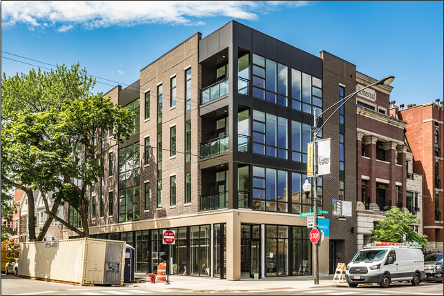 a building on a city street with a van