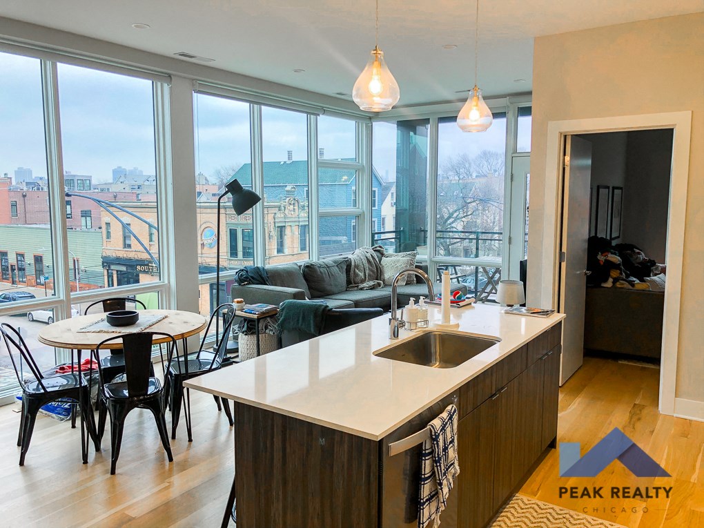a kitchen and living room with a view of the city
