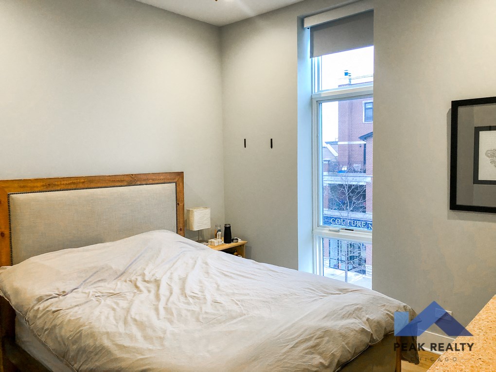 a bedroom with a bed and a window