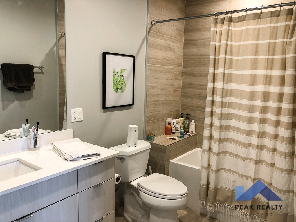 a bathroom with a toilet and a shower and a sink