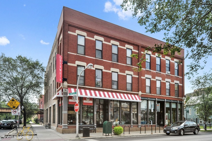 a red brick building on the corner of a city street