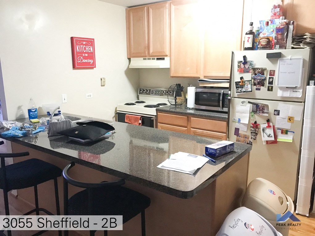 a kitchen with a counter top and a refrigerator