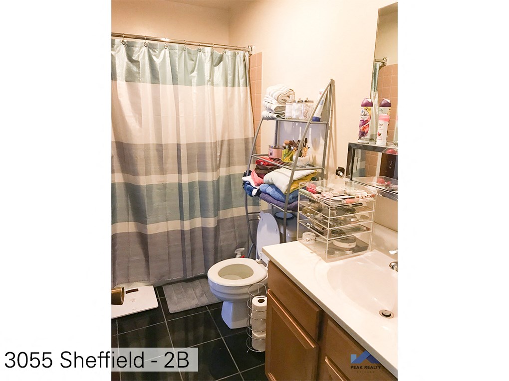 a bathroom with a shower and a toilet and a sink