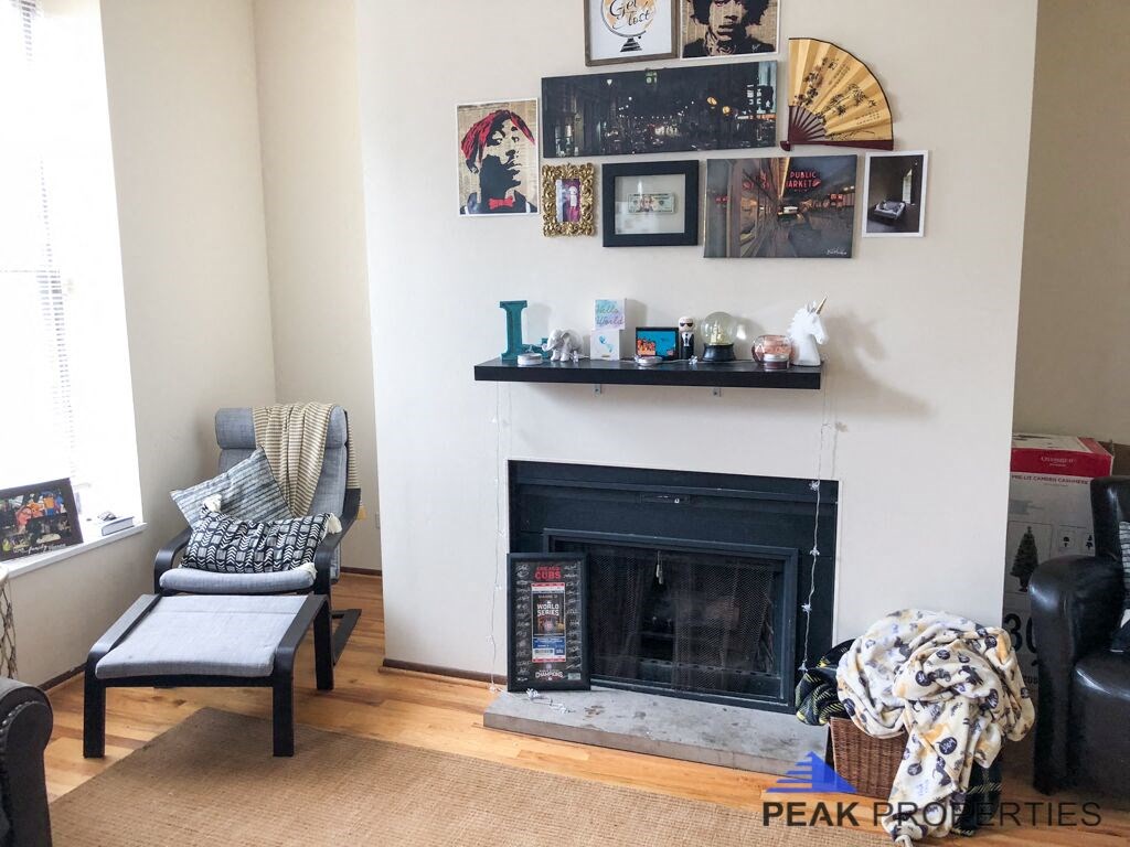 a living room with a fireplace and pictures on the wall