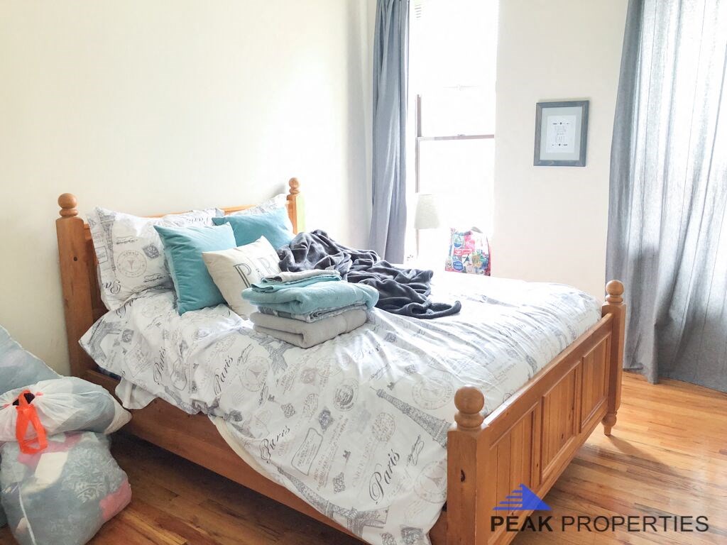 a bedroom with a bed and some pillows on it