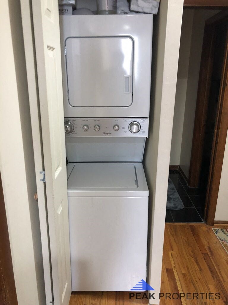 a white washer and dryer in a closet