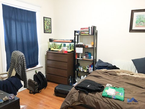 a bedroom with a bed and a fish tank in it