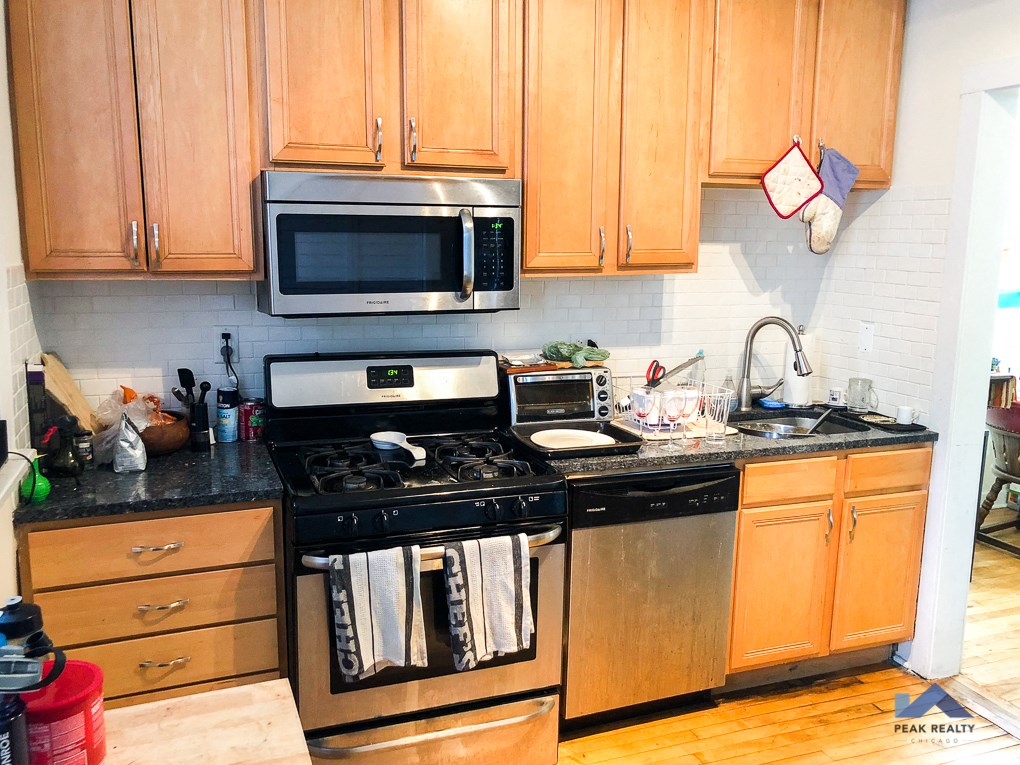 a kitchen with stainless steel appliances and wooden cabinets